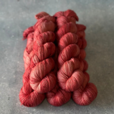 Tonal yarn in deep coral red.