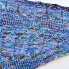 Triangular scarf that begins with the smallest corner and finishes at the widest edge. Techniques include twisted rib, leaf lace, and nupps.