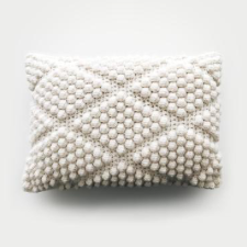 Rectangular pillow with bobbles in a diamond pattern.
