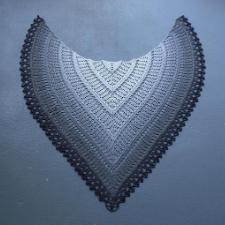 Deep, arced shawl, nearly heart-shaped, in concentric rows that miter the spine in a gray gradient, light in the center to a dark edge.