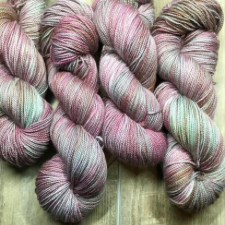 Variegated yarn in faded greens and pinks.