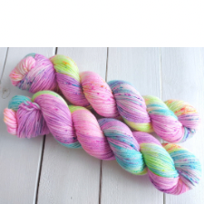 Variegated pink yarn with splashes of blue, yellow and green.