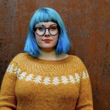 Colorwork pullover with row of pine trees across the yoke.