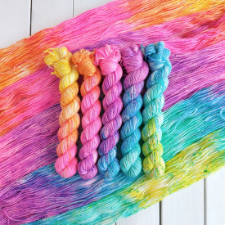 Mini skeins in variegated deep pastels in yellow, blue and pink.