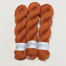 Semi-solid pumpkin-color yarn.