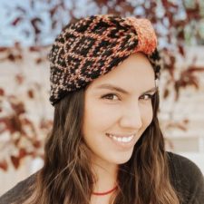 Jennifer smiles modeling two-color headband with diamond-motif colorwork.