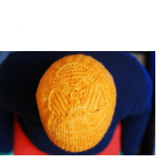 Top of beanie has three-lobed textured design.