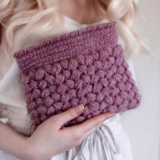 Crocheted clutch with flat band at top, then puffy stitches throughout.