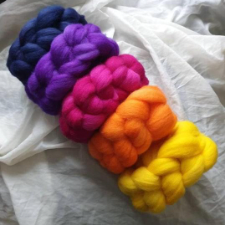 Five semisolid roving braids in rainbow shades.