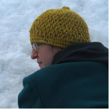 Crocheted beanie comes to blunt point.