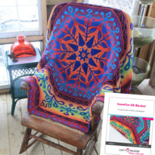 Double-knitted blanket with large snowflake kaleidoscope design.