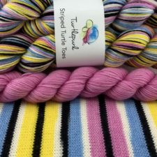 Self-striping yarns in pastels and black and white.