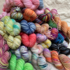 Pile of variegated and tonal 20 gram skeins.