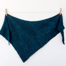Assymmetric triangular textured shawl.