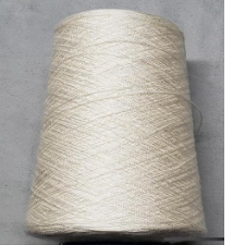 A large, undyed cone of tencel yarn.