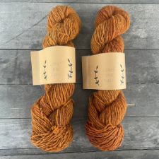Two skeins of yarn the color of spiced pumpkin pie filling.