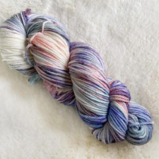 Variegated yarn in soothing, cool colors on a cream base.