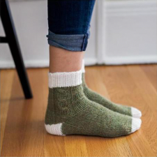 Worsted weight socks with a cable down the outside of each.