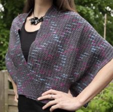 Crocheted wrap with a solid fabric and soft zigzag color patterns