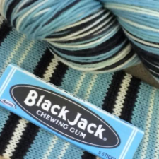 Light blue and black pack of Black Jack gum with neat stripes in light blue, black and white.