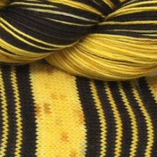 Rich yellow yarn with groups of five black stripes.