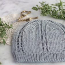Simple beanie divided into sections vertically by parallel purl rows.