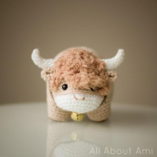 Adorable crocheted amigurumi Ox with bell and horns.