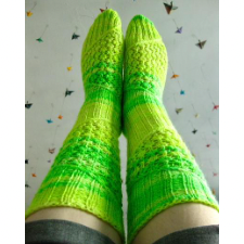 Spiral pattern that alternates lace and ribbing covers these tall socks.