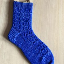 Socks with tiny cabled stitches that form rings like a wedding ring quilt.