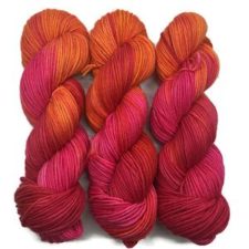 Bright, variegated yarn in fuchsia and canteloupe colors.