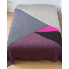 Bedspread made of triangles in different colors.