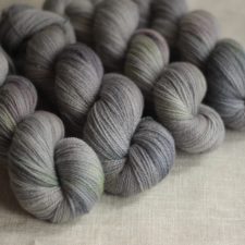 Cool neutral skeins with subtle splashes of darker neutral and a contrasting spring color.