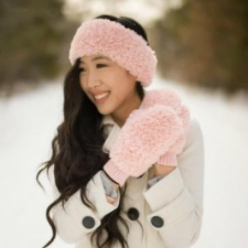 Crocheted fuzzy pink earwarmer and fluffy mittens.