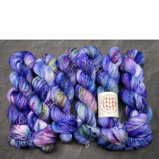 Bright blue-violet variegated yarn with deep pinks, brown and blue greens.