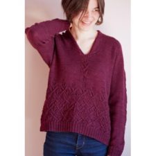 Long-sleeve V-neck pullover with eyelet elements on the sleeves and in the first six inches or so from the bottom hem.