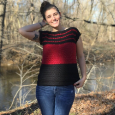 Rectangular construction crocheted sleeveless top in two colors, with a wide panel of each at the bottom, then thinner stripes across the yoke.