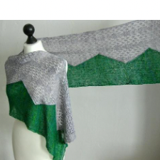 Long, rectangular shawl is split in half horizontally with a zigzag border between the top and bottom. Top is lace, bottom is solid in a complementary color.