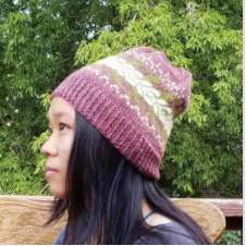 Four-color stranded colorwork hat with leafy motifs.