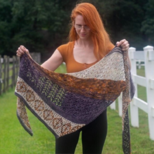 Triangular shawl with stripes in various textures and colorwork patterns.