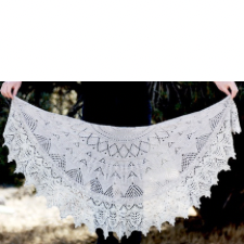 Crescent laceweight shawl with edges blocked to points and lace throughout.