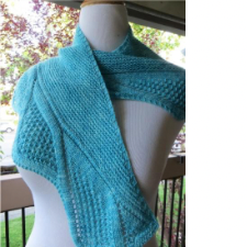 Shallow triangular shawl with textured wave shapes along the bottom edge.