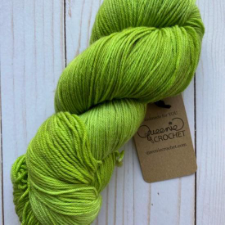 Bright, semi-solid skein in the color of tart “pie apples.”