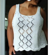 Knitted tank top with latticework sides and double diamond pattern on the front in eyelets. Tank has a scalloped hem.