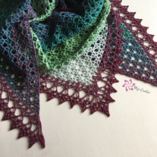 Triangular netted shawl made from the point upward, then a hem is added last.