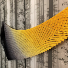 Shawl slowly increases in length to form gentle asymmetric triangle that resembles feather.