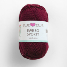 Skein of maroon sport weight yarn.