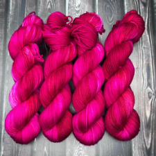 Ultra-bright fuchsia and red variegated yarn.