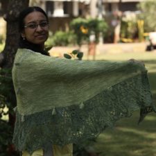 Shawl in two shades of same color with wide lace bottom edge and small tassels throughout.