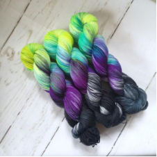 Variegated yarn goes from black to neon in four colors.