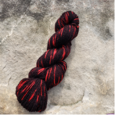 Primarily black yarn with bright, warm streaks.
